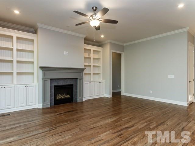 6920 Ray Family Farm Court, Unit LT20 Raleigh, NC 27613 - Photo 7 of 22 a view of an empty room with a fireplace and a window