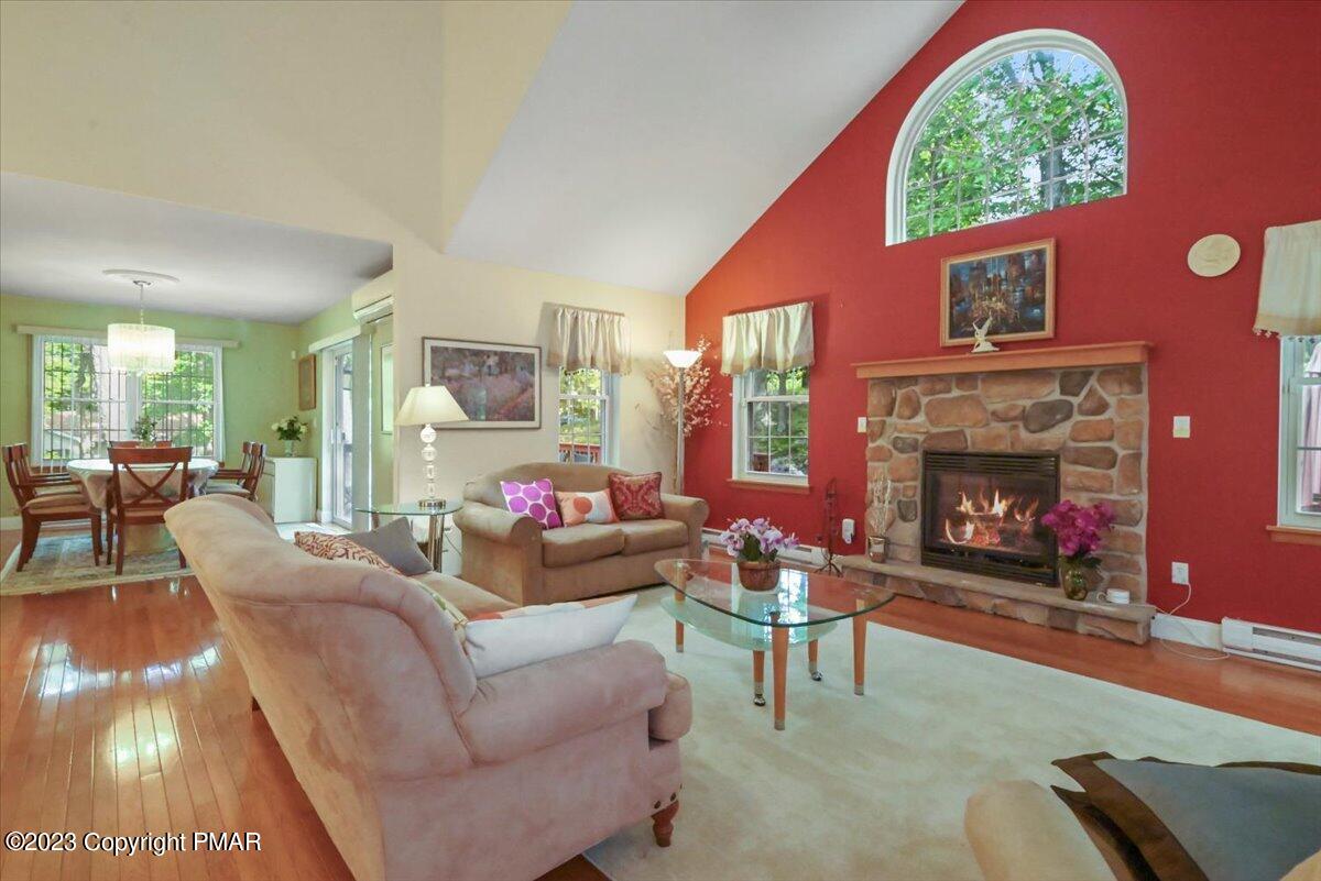 105 Alford Court Bushkill, PA 18324 - Photo 12 of 64 a living room with furniture a fireplace and a large window