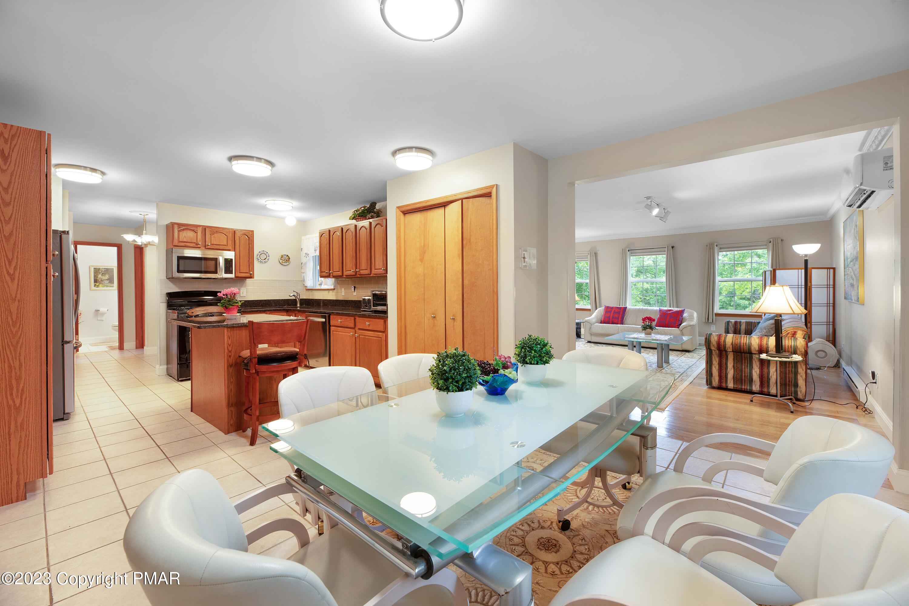 105 Alford Court Bushkill, PA 18324 - Photo 16 of 64 a living room with stainless steel appliances furniture a dining table and kitchen view