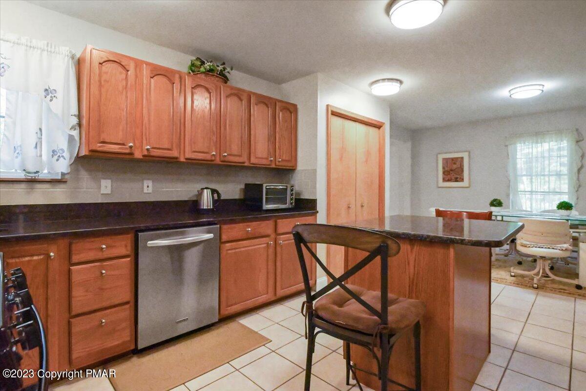 105 Alford Court Bushkill, PA 18324 - Photo 22 of 64 a kitchen with stainless steel appliances granite countertop a stove a sink and a refrigerator