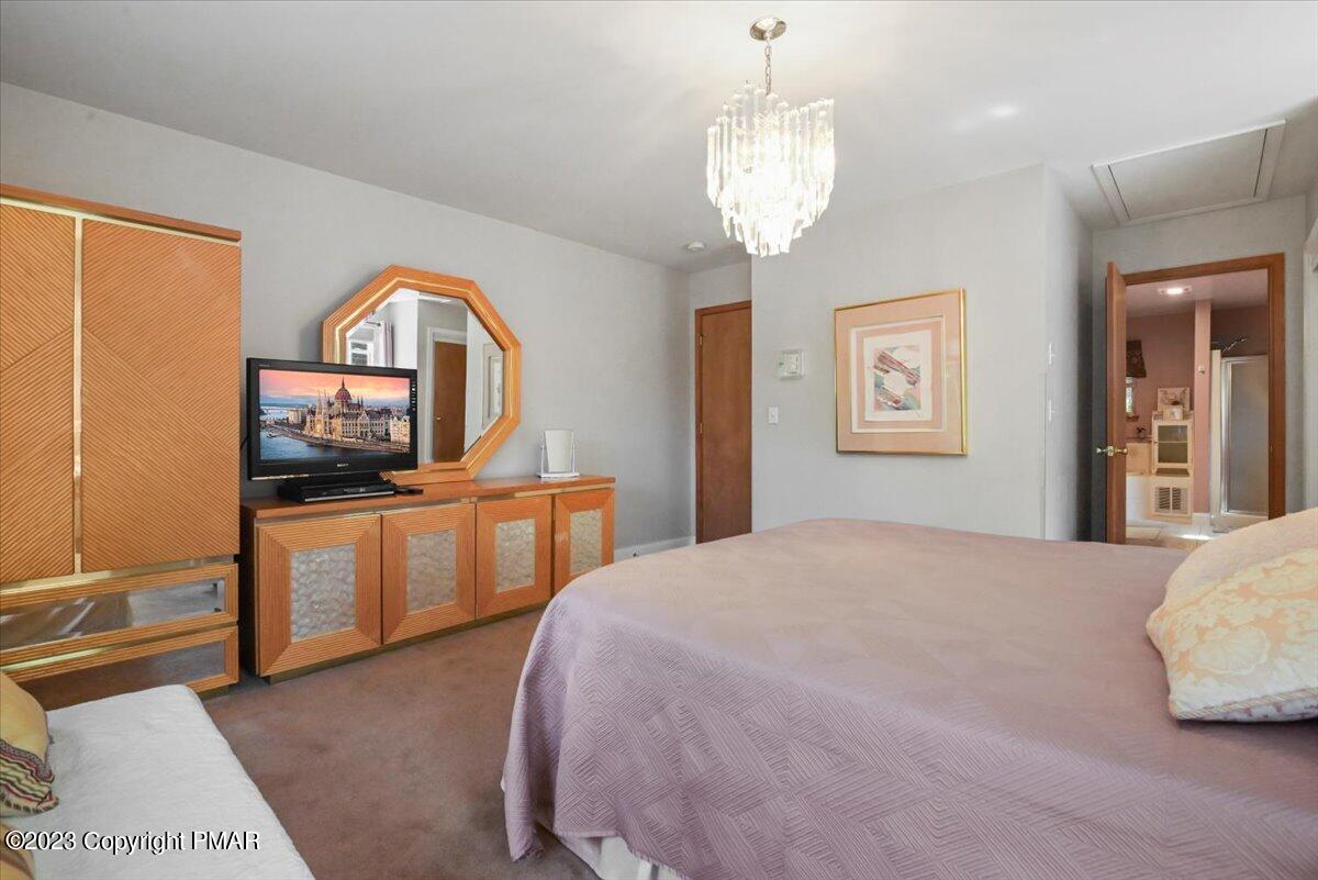 105 Alford Court Bushkill, PA 18324 - Photo 25 of 64 a bedroom with a bed and a flat screen tv