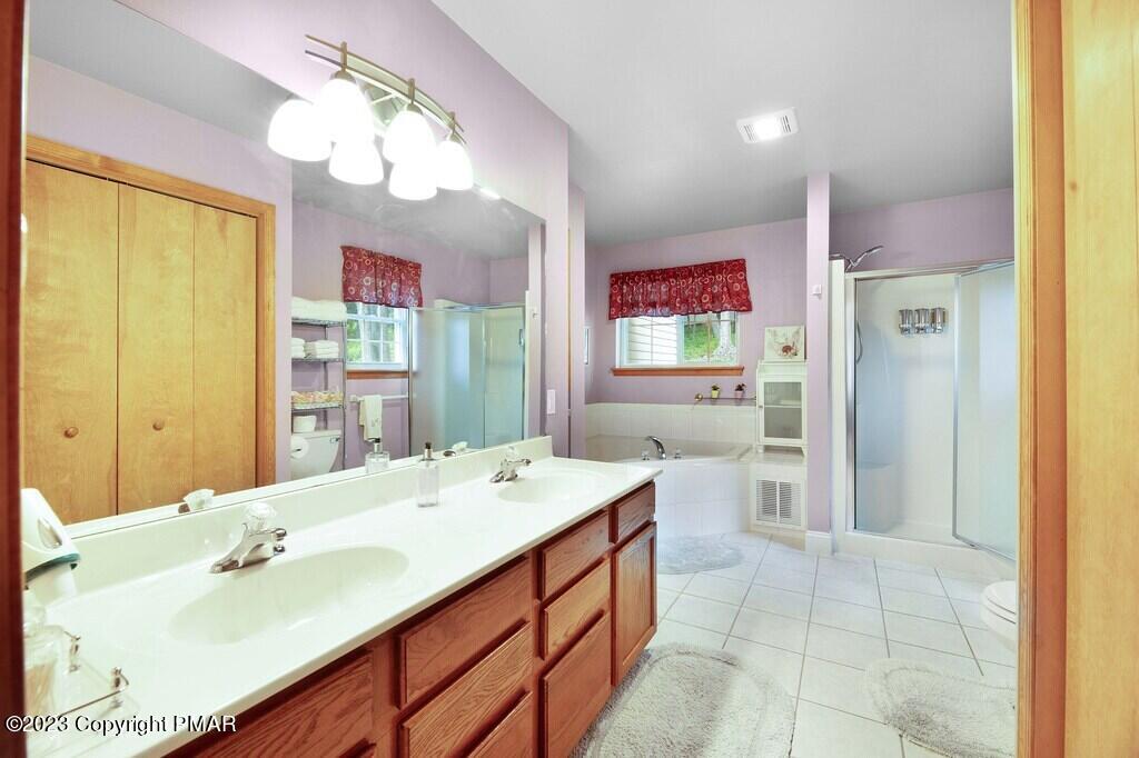 105 Alford Court Bushkill, PA 18324 - Photo 26 of 64 a spacious bathroom with a sink a mirror and a shower