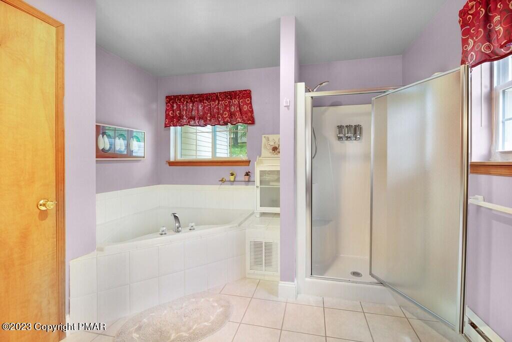105 Alford Court Bushkill, PA 18324 - Photo 28 of 64 a bathroom with a bathtub and a shower