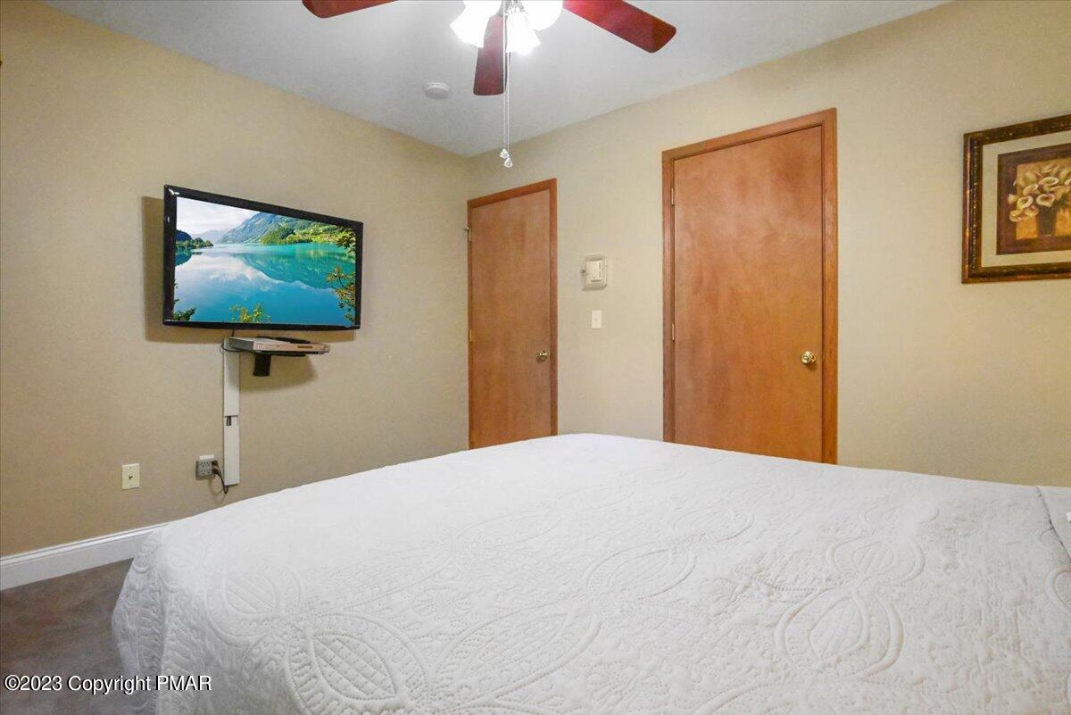 105 Alford Court Bushkill, PA 18324 - Photo 34 of 64 a bedroom with a bed and a chandelier