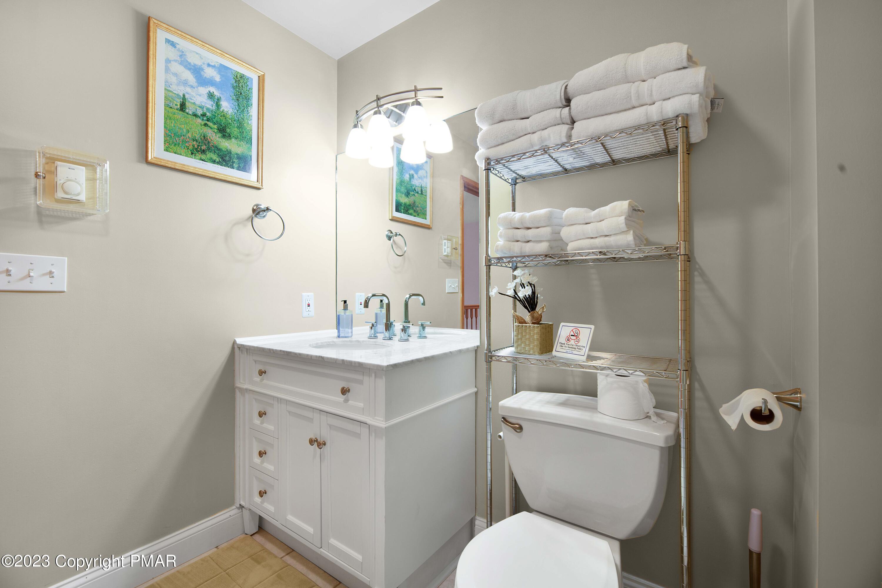 105 Alford Court Bushkill, PA 18324 - Photo 37 of 64 a bathroom with a toilet sink and mirror