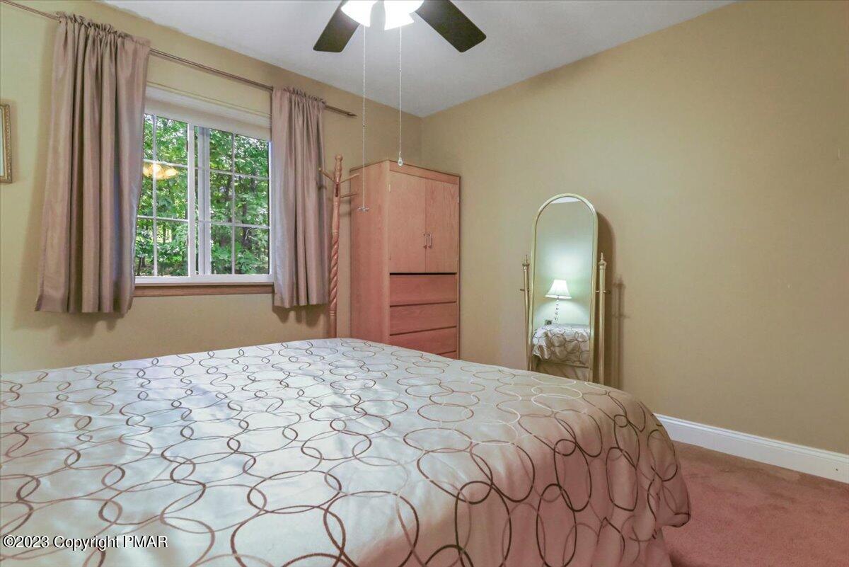 105 Alford Court Bushkill, PA 18324 - Photo 38 of 64 a bedroom with a bed and a dresser next to a window