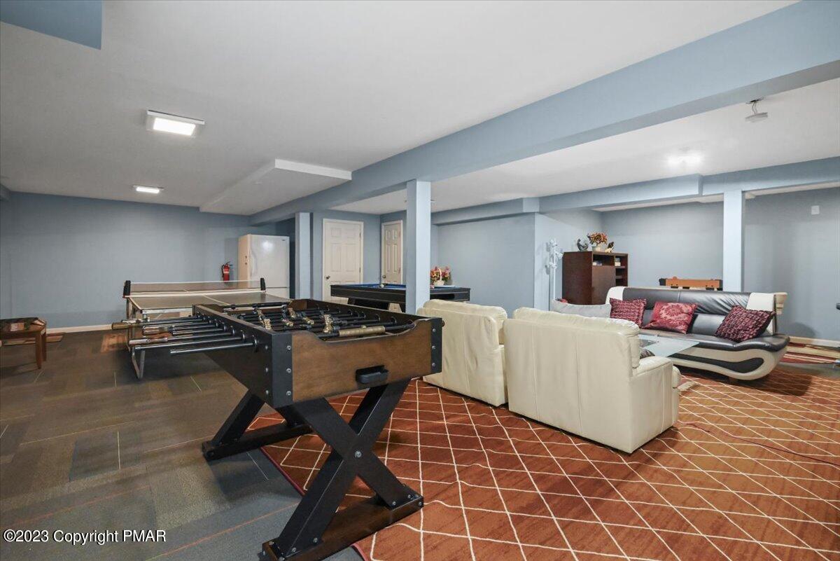 105 Alford Court Bushkill, PA 18324 - Photo 41 of 64 a living room with furniture a table and a rug
