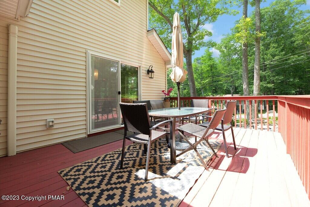 105 Alford Court Bushkill, PA 18324 - Photo 59 of 64 a view of a patio with table and chairs and wooden floor