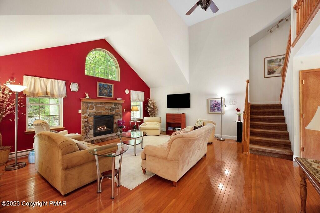 105 Alford Court Bushkill, PA 18324 - Photo 9 of 64 a living room with furniture a fireplace and a flat screen tv