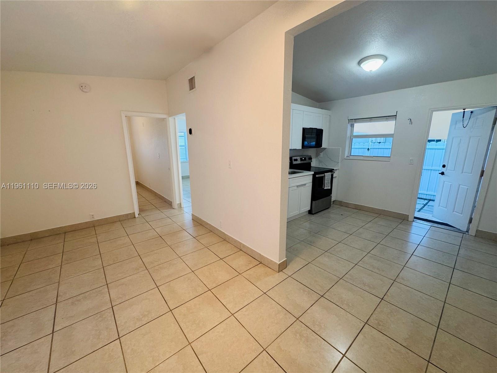1340 Northwest 60th Street, Unit 1340 Miami, FL 33142 - Photo 3 of 14 a view of a livingroom with an empty space and a sink