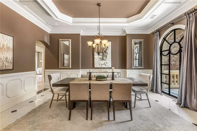 a dining room with furniture a chandelier and a rug