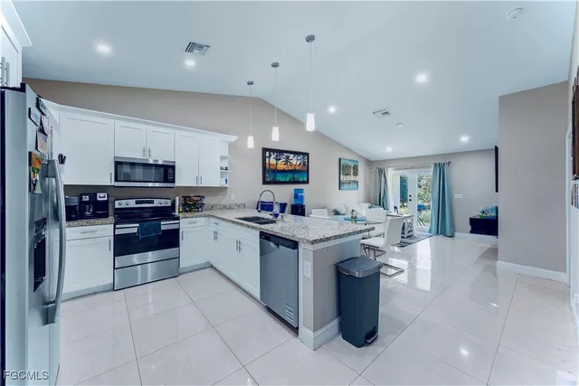a kitchen with a stove top oven and cabinets