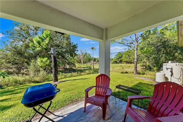 a view of a chairs in backyard of the house