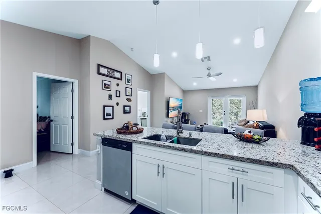 a kitchen with granite countertop a sink and cabinets