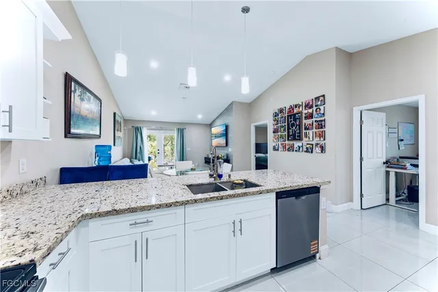 a kitchen with granite countertop a sink and cabinets