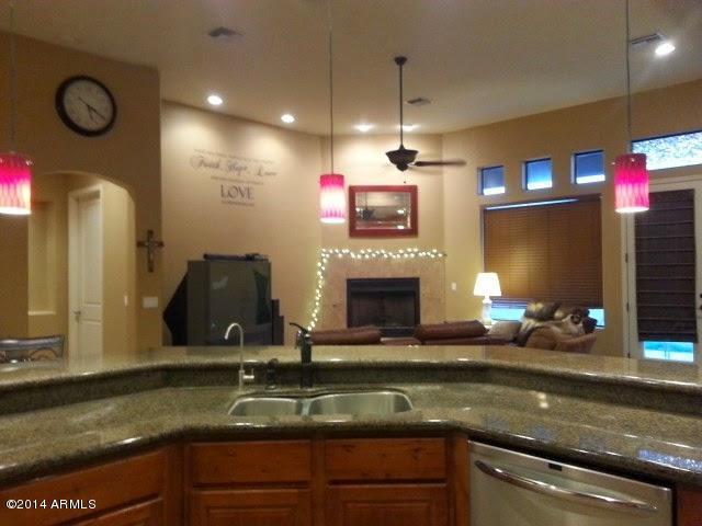 22630 West Beverly Road Buckeye, AZ 85326 - Photo 12 of 23 a kitchen with sink refrigerator and fireplace