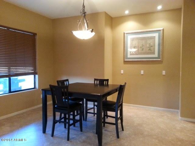 22630 West Beverly Road Buckeye, AZ 85326 - Photo 8 of 23 a view of a dining room with furniture and chandelier
