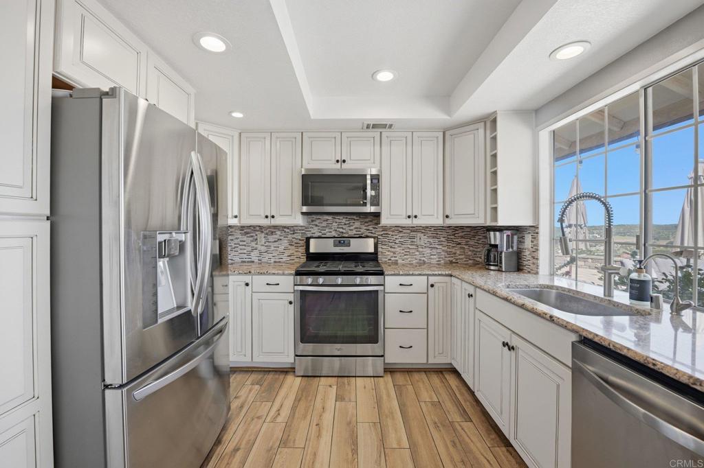37875 Sage Road Hemet, CA 92544 - Photo 11 of 33 a kitchen with a refrigerator sink and microwave