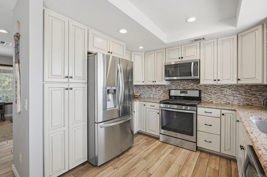 37875 Sage Road Hemet, CA 92544 - Photo 12 of 33 a kitchen with stainless steel appliances a refrigerator stove and sink