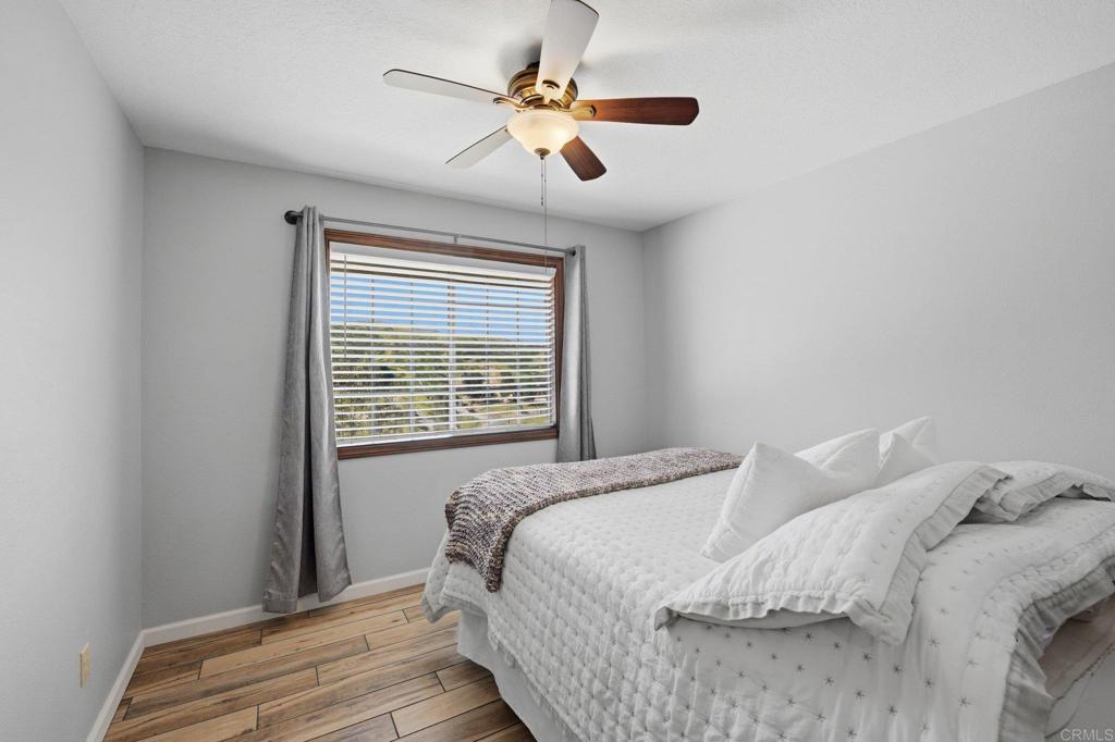 37875 Sage Road Hemet, CA 92544 - Photo 16 of 33 a bedroom with a bed and a chandelier