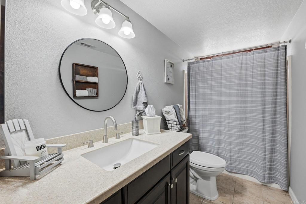 37875 Sage Road Hemet, CA 92544 - Photo 17 of 33 a bathroom with a sink a toilet and a mirror