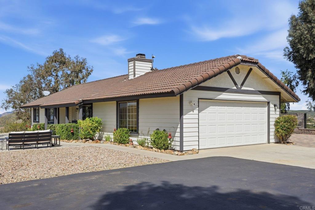 37875 Sage Road Hemet, CA 92544 - Photo 29 of 33 a front view of a house with a yard and garage