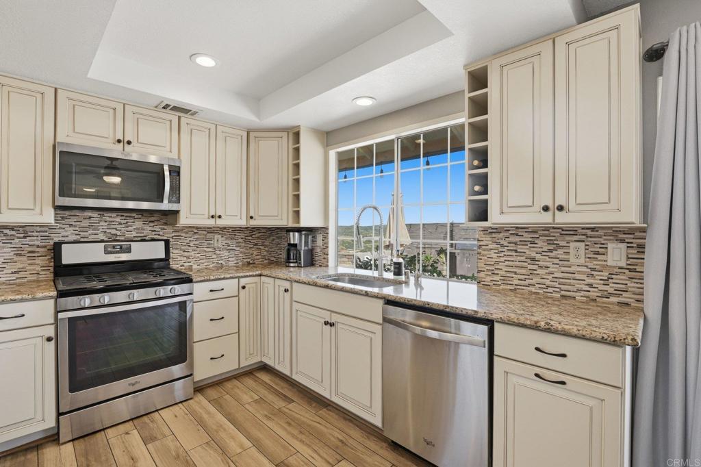 37875 Sage Road Hemet, CA 92544 - Photo 5 of 33 a kitchen with granite countertop cabinets stainless steel appliances and a sink