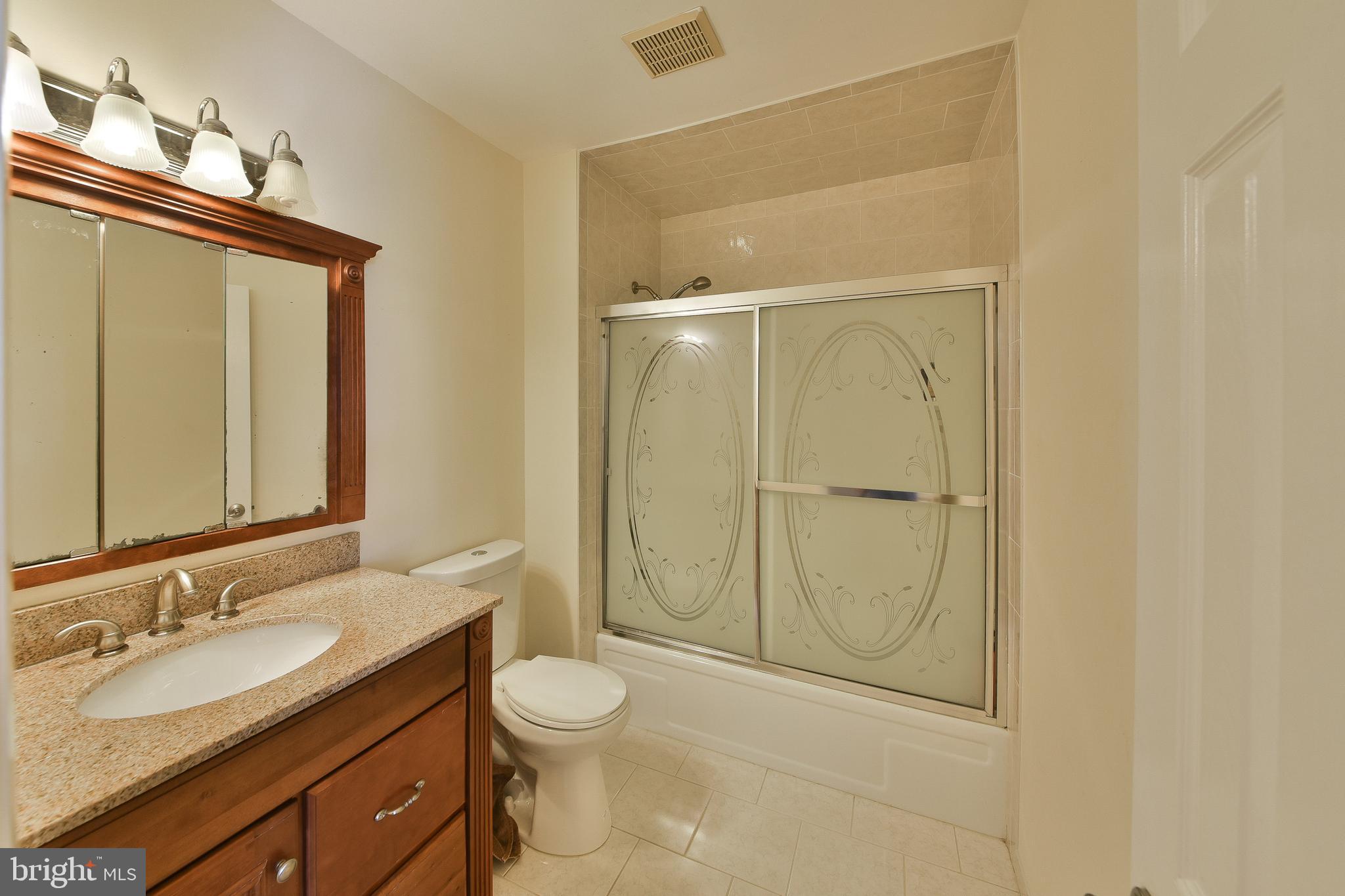 3403 Honey Run Road Ambler, PA 19002 - Photo 20 of 35 a bathroom with a granite countertop sink toilet and shower