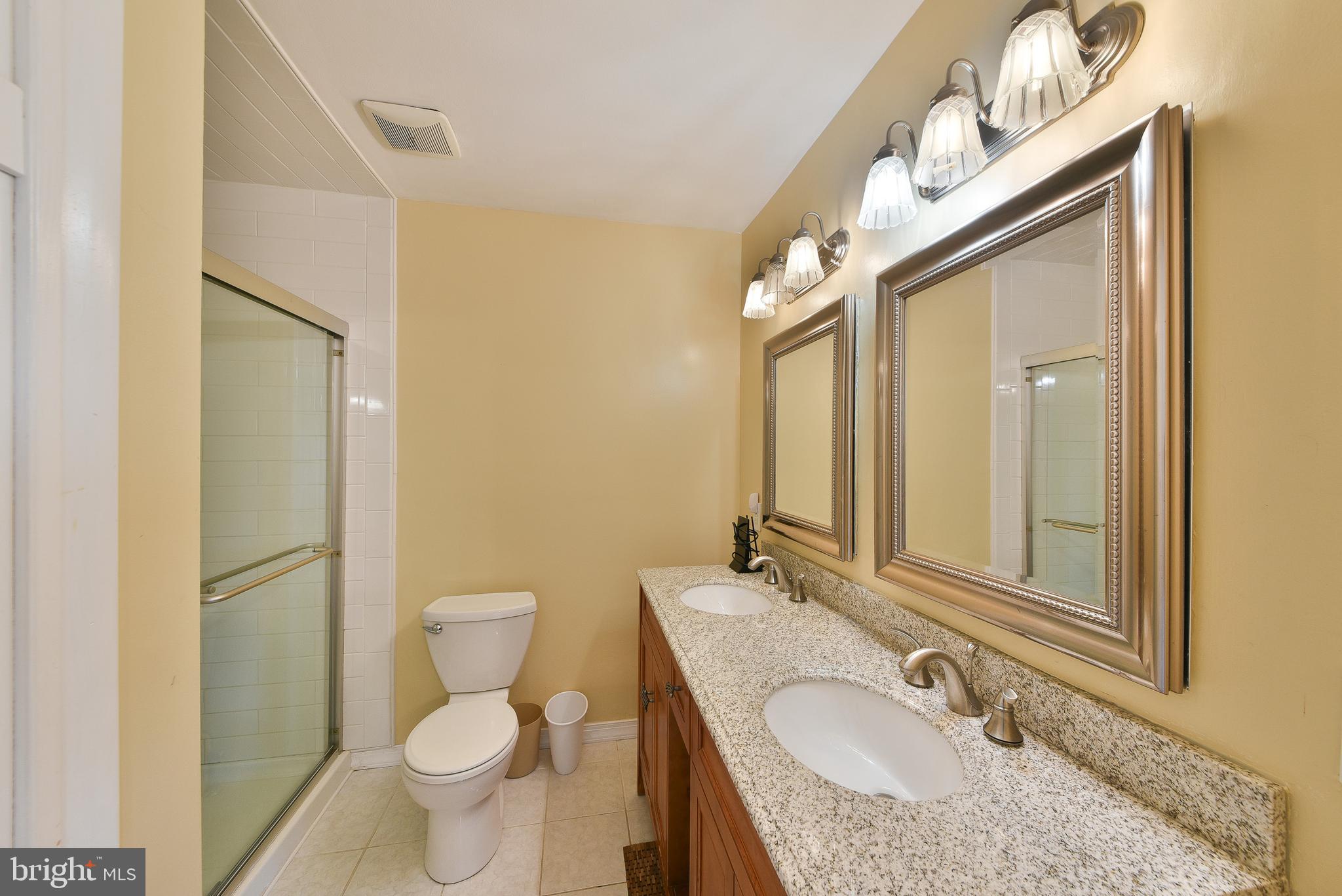 3403 Honey Run Road Ambler, PA 19002 - Photo 23 of 35 a bathroom with a granite countertop sink toilet and shower