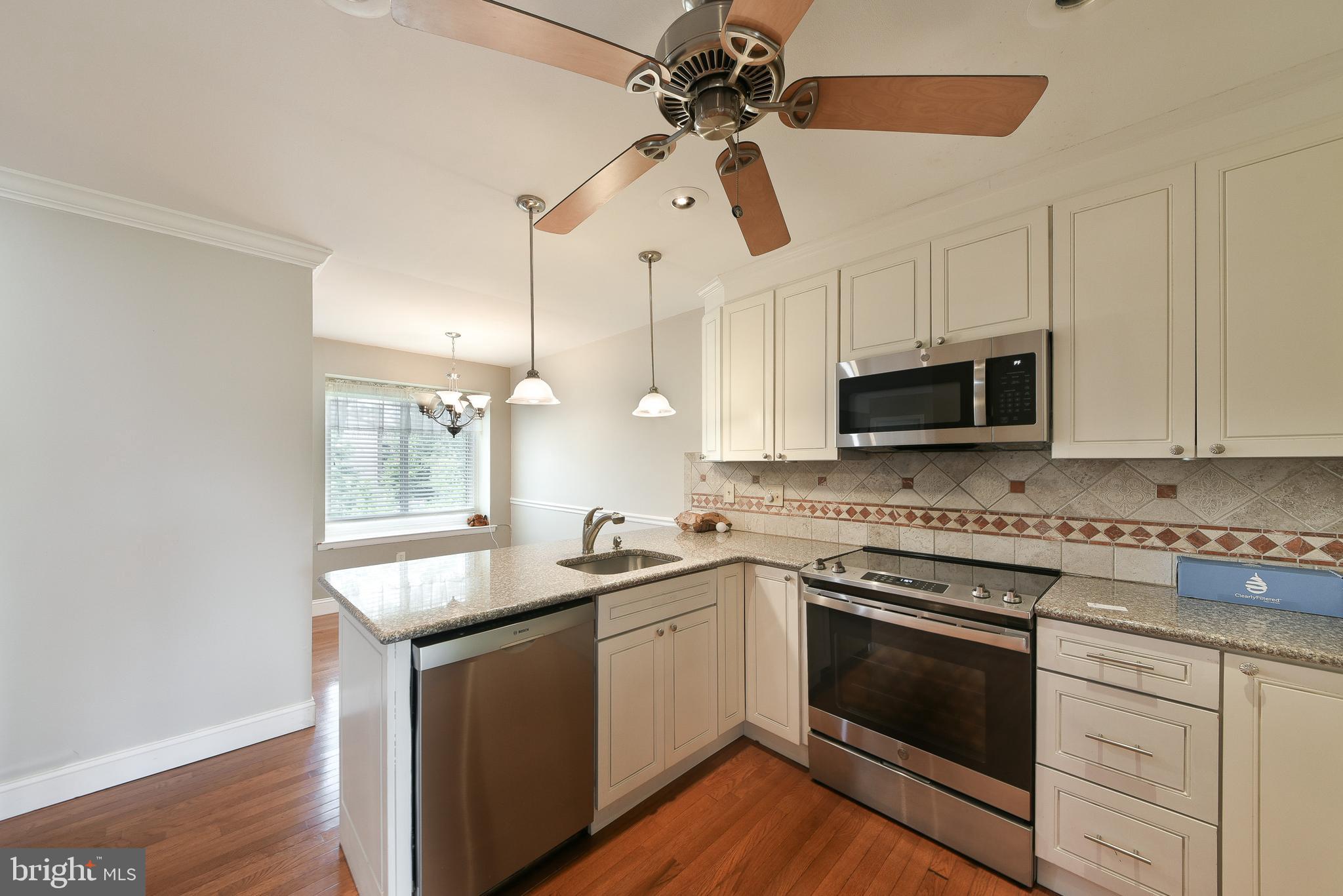 3403 Honey Run Road Ambler, PA 19002 - Photo 10 of 35 a kitchen with stainless steel appliances granite countertop a sink a stove top oven a counter space and cabinets