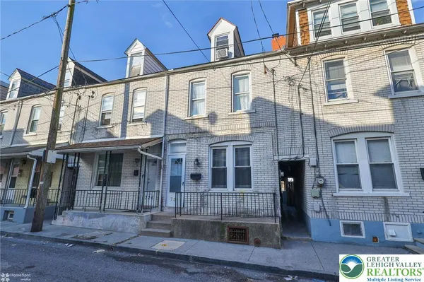 a front view of a residential apartment building with glass windows