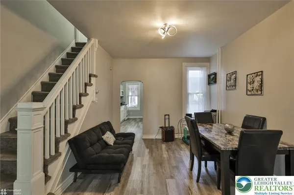 a view of a livingroom with furniture a table and chairs