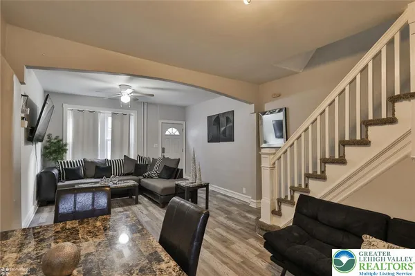 a living room with furniture and wooden floor
