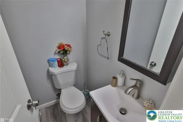 a white toilet sitting next to a bathroom sink