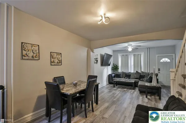 a view of a livingroom with furniture and a dining table