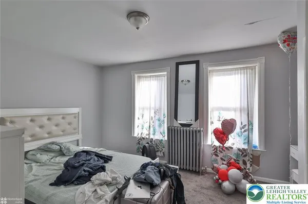 a bedroom with bed and a window