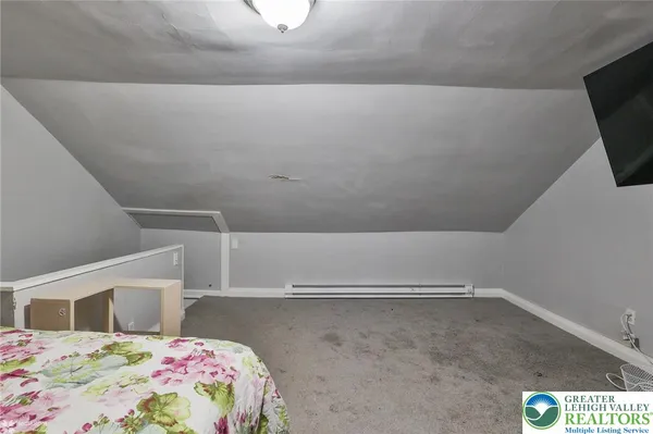 a bedroom with a bed and flat screen tv