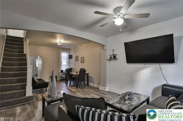 a living room with furniture and a flat screen tv