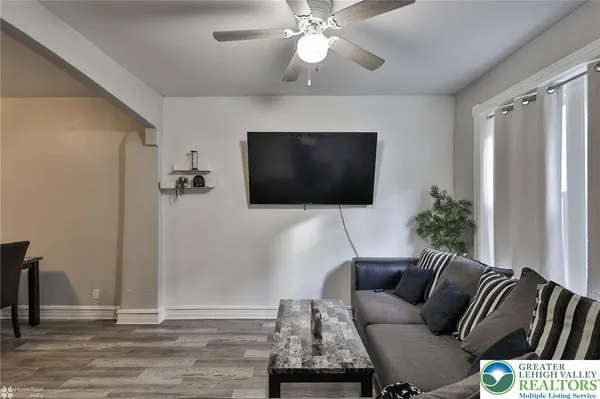 a living room with furniture and a flat screen tv