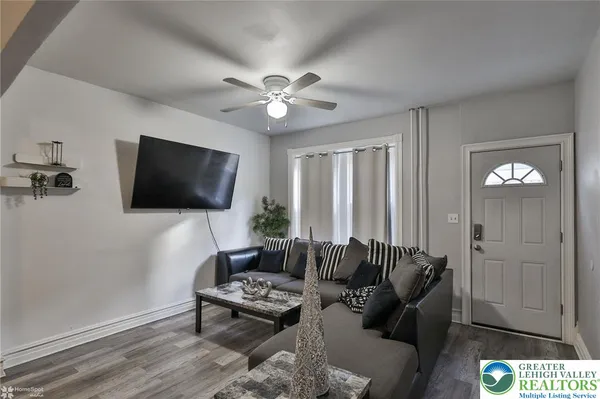 a living room with furniture and a flat screen tv