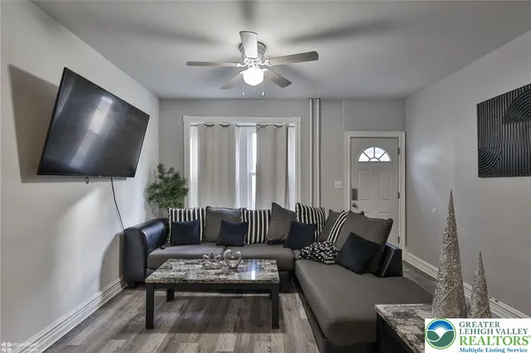a living room with furniture and a flat screen tv