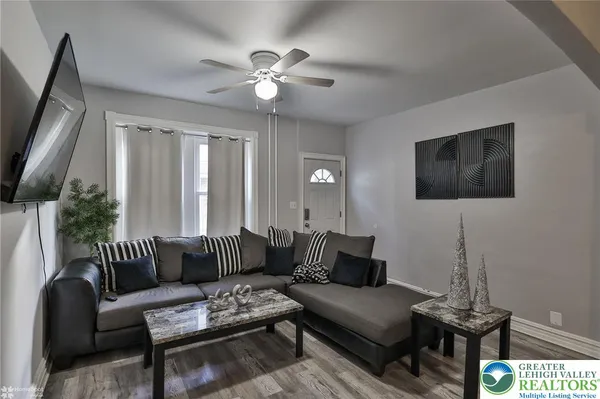 a living room with furniture and a flat screen tv