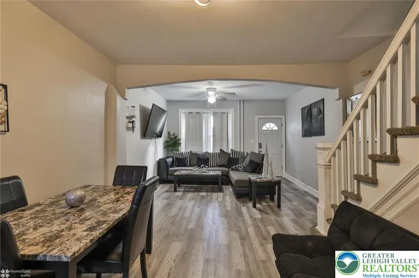 a living room with furniture and a wooden floor