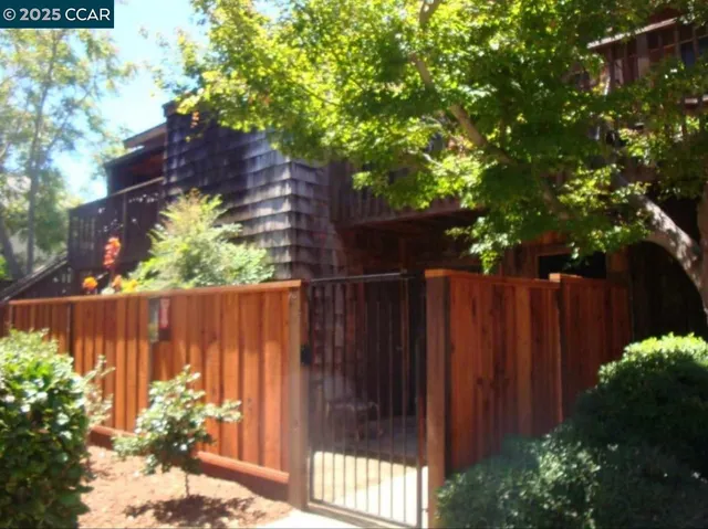 a view of a fence with a flower garden