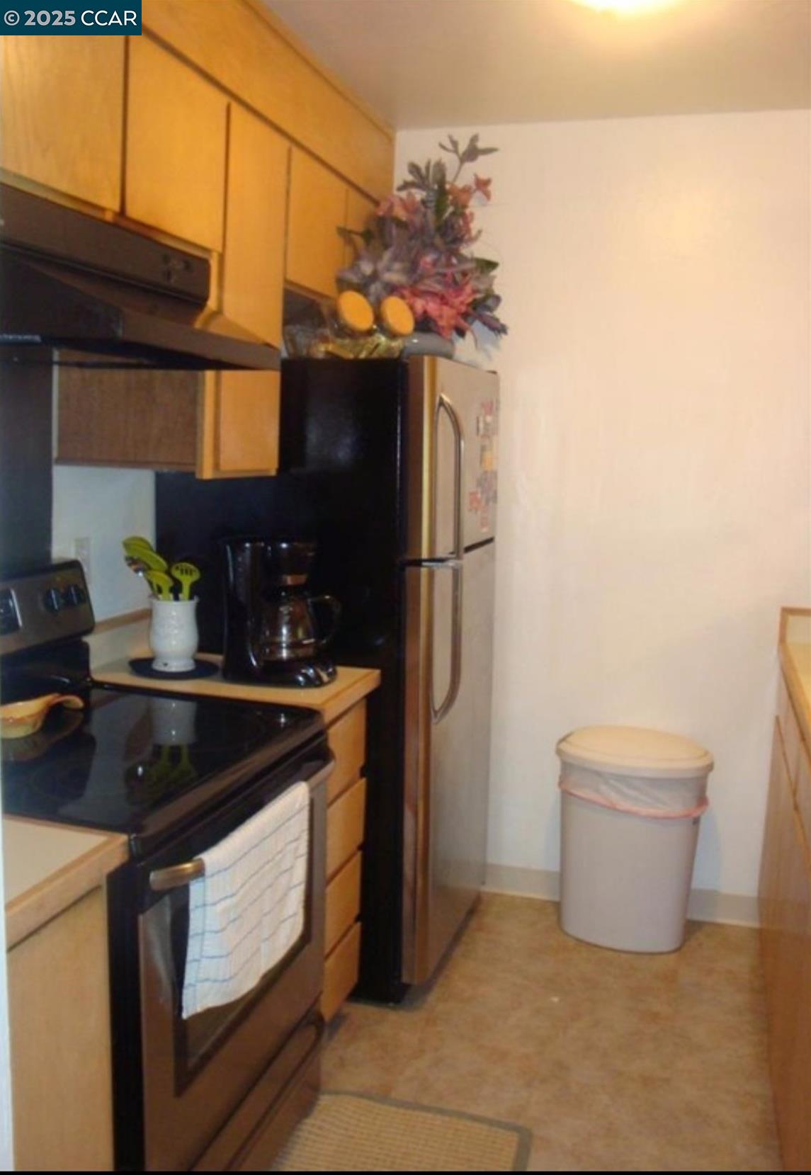 2450 Walters Way, Unit 27 Concord, CA 94520 - Photo 2 of 2 a kitchen with stainless steel appliances granite countertop a sink a stove a refrigerator and a microwave