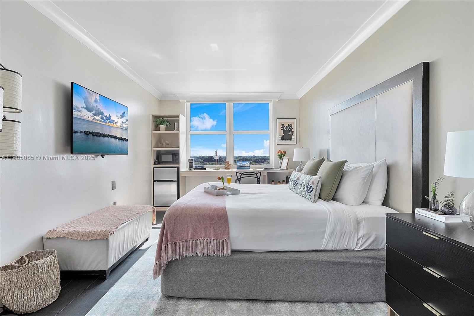 2889 McFarlane Road, Unit 902 Miami, FL 33133 - Photo 11 of 62 a bedroom with a large bed couch and a window