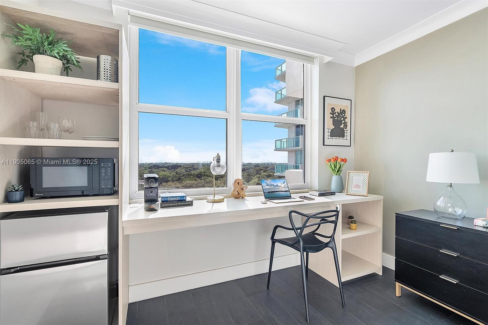 2889 McFarlane Road, Unit 902 Miami, FL 33133 - Photo 16 of 62 a room with a table chairs and a stove top oven