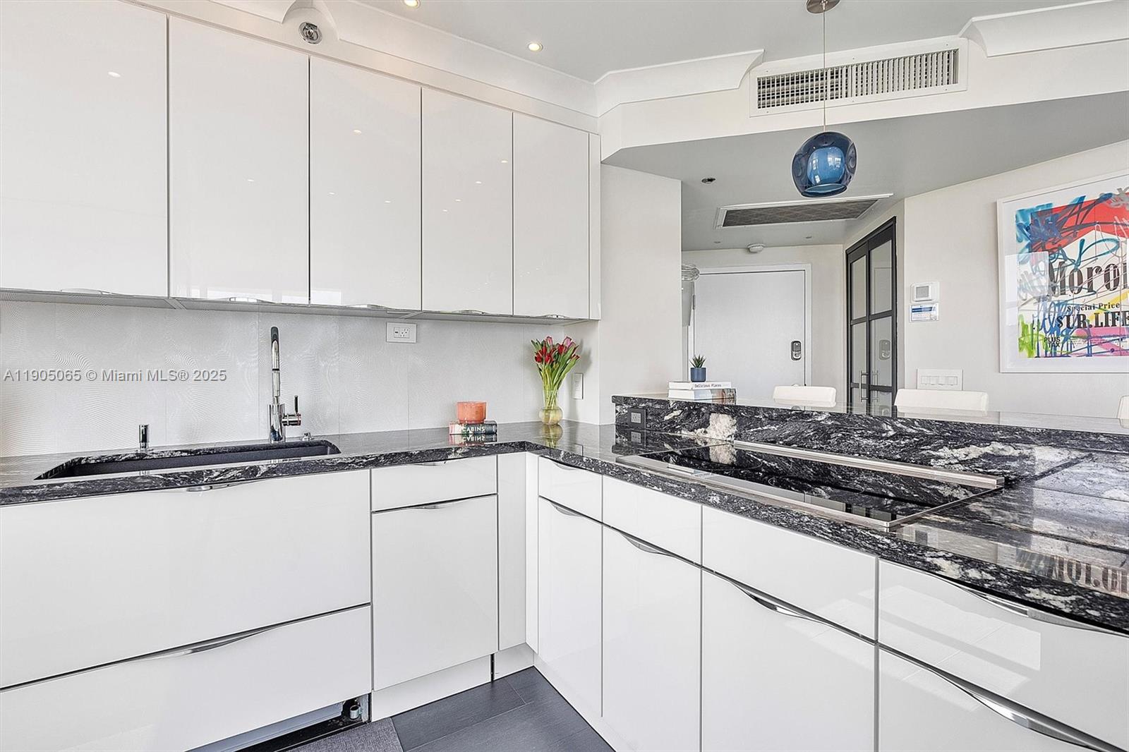 2889 McFarlane Road, Unit 902 Miami, FL 33133 - Photo 19 of 62 a kitchen with stainless steel appliances granite countertop a sink and a stove