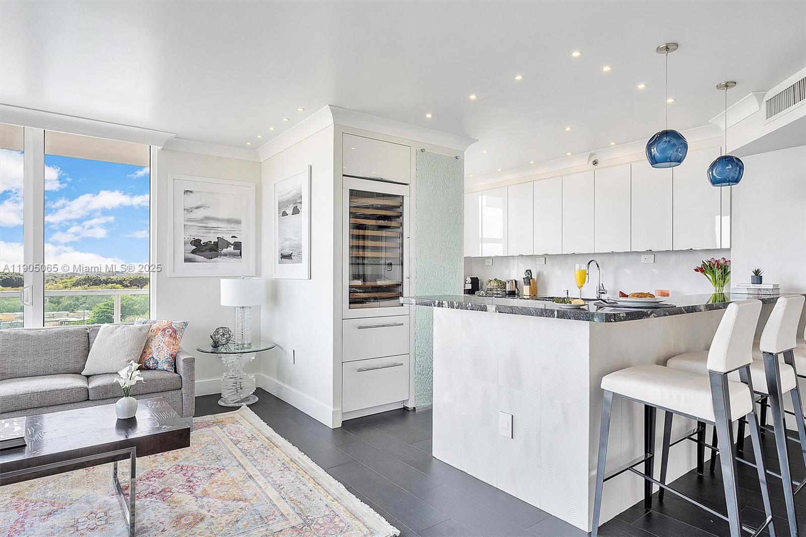 2889 McFarlane Road, Unit 902 Miami, FL 33133 - Photo 20 of 62 a kitchen with white cabinets and sink