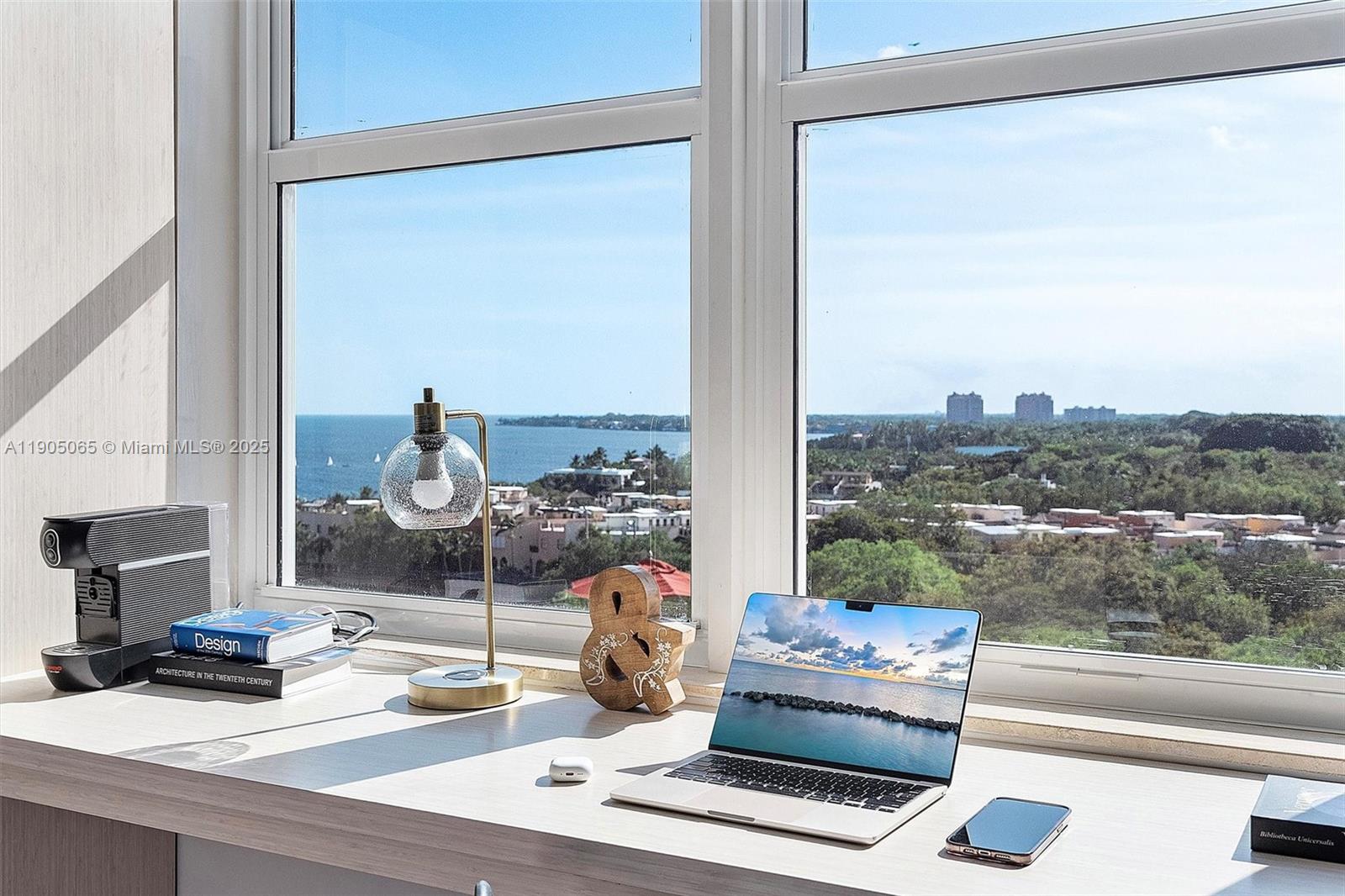 2889 McFarlane Road, Unit 902 Miami, FL 33133 - Photo 24 of 62 a living room with furniture and a floor to ceiling window